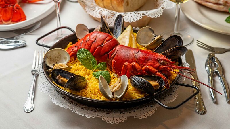 Lobster with yellow rice and clams entree